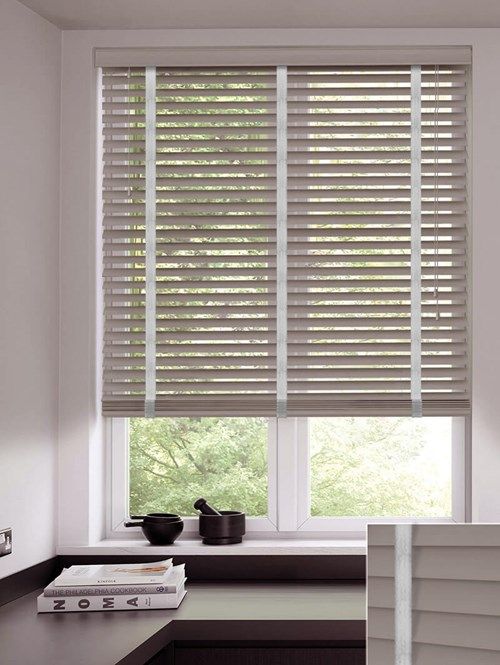 a kitchen with white walls and wooden blinds on the windowsills, along with a counter top