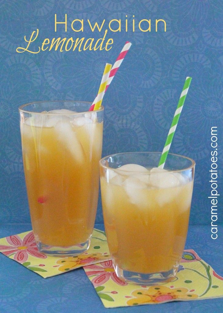 two glasses filled with lemonade sitting on top of a blue table cloth next to each other