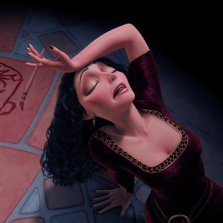 a woman with long black hair laying on the ground next to a red tile floor