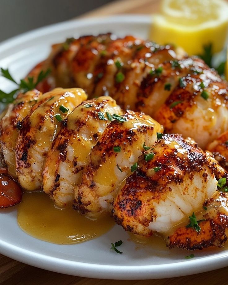 grilled shrimp on a white plate with lemon wedges