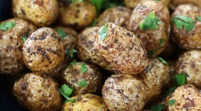 a close up view of some potatoes with parsley on it's top surface