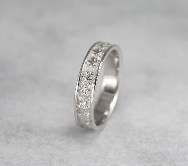 a white gold wedding ring with princess cut diamonds