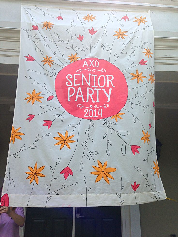 a banner hanging from the side of a building that says axq senior party on it