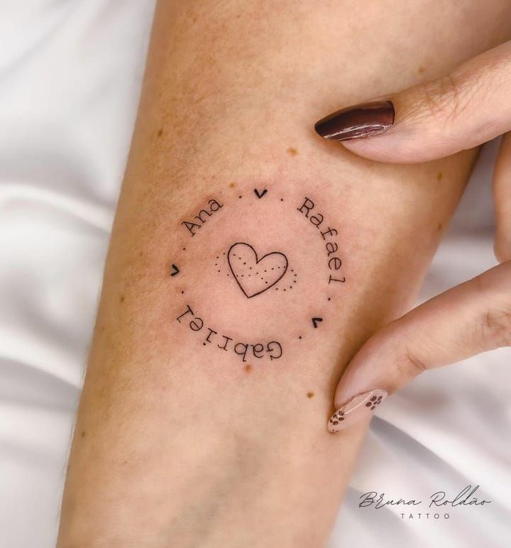 a woman's arm with a tattoo that says i love you and heart shaped