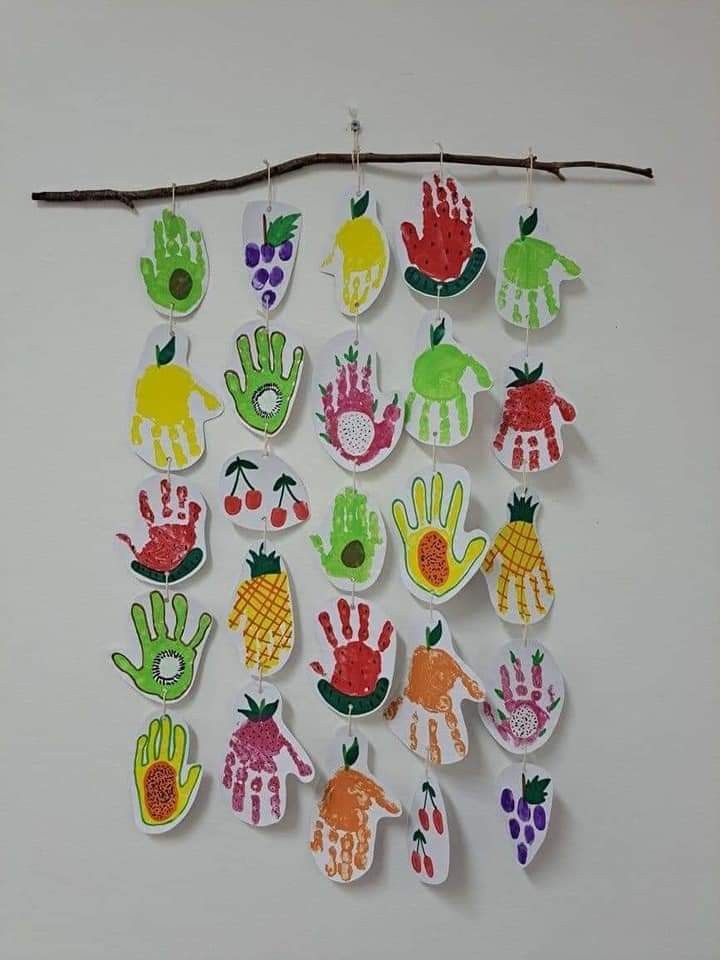 a bunch of handprints are hanging on a sticker with clothes pins attached to it