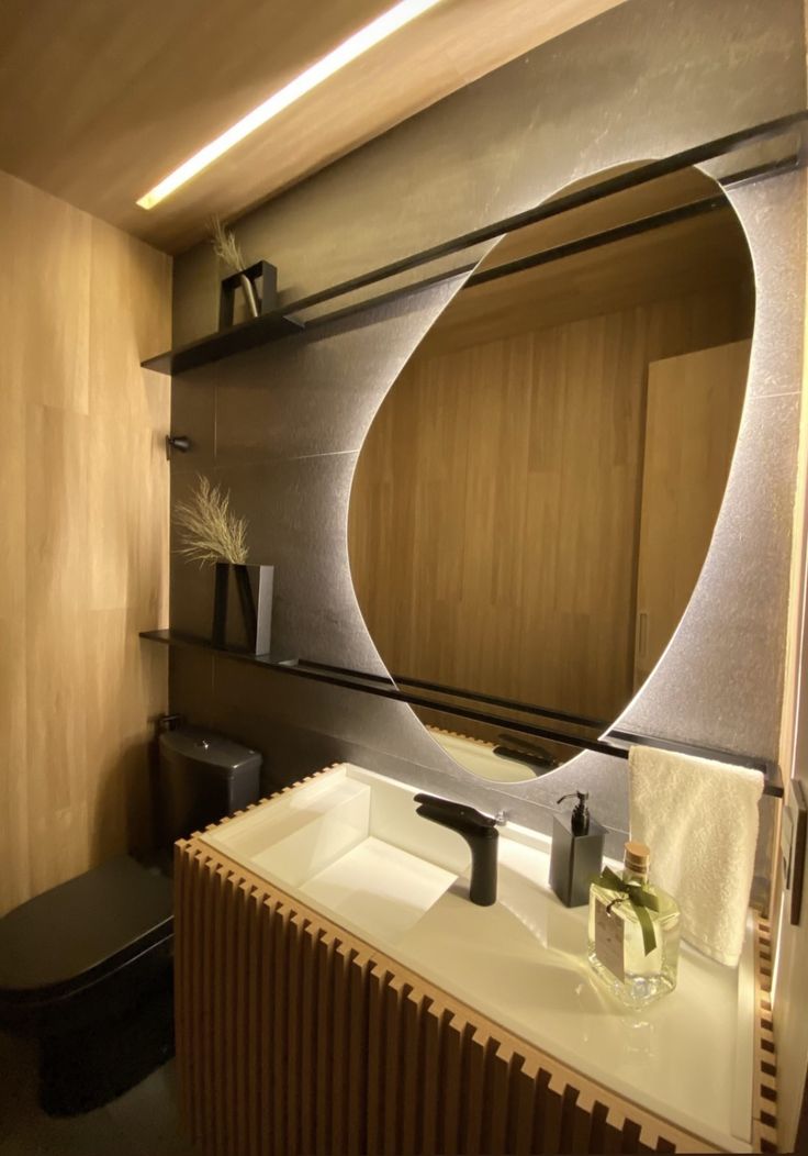 a bathroom with a sink, mirror and toilet