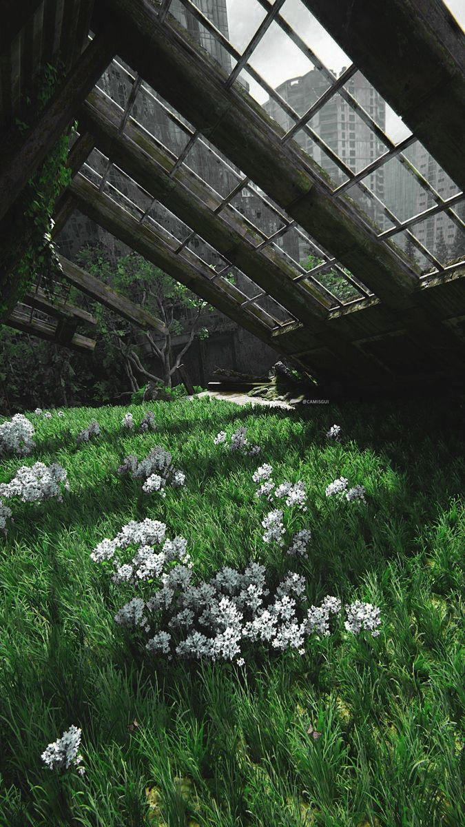 blue flowers are growing in the grass under an overpass