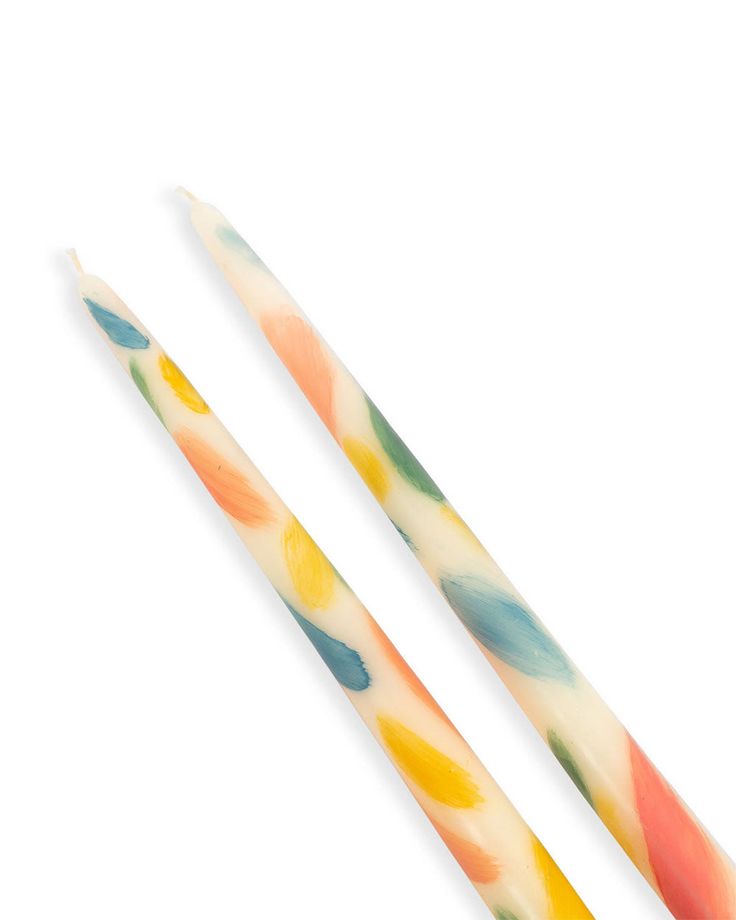 two colorful toothbrushes sitting next to each other