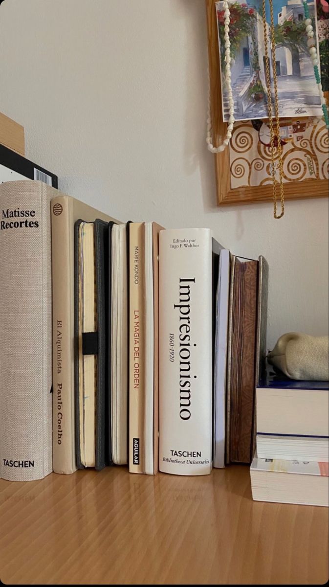 a row of books sitting on top of a wooden table