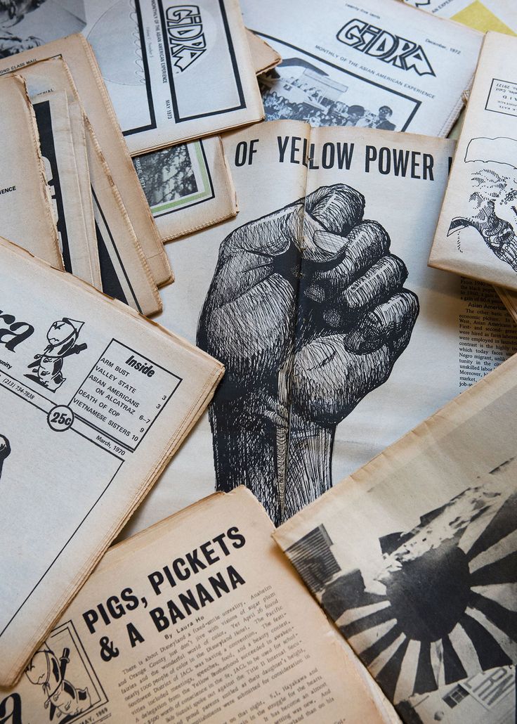 an assortment of old newspapers with black and white images on them, including one showing a fist