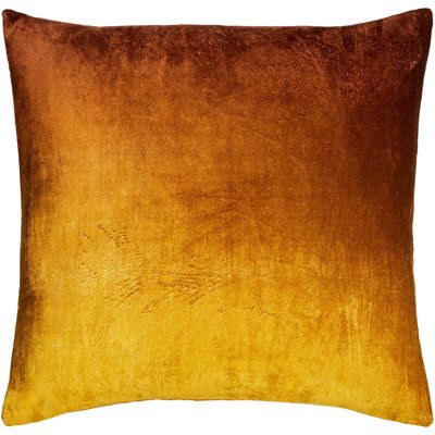 an orange and brown pillow on a white background