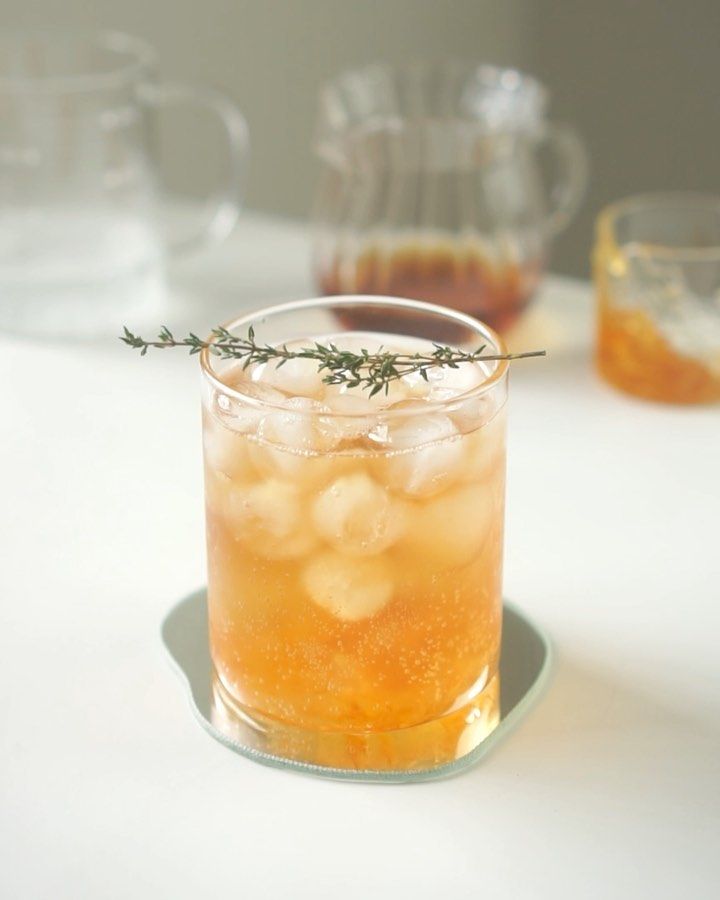 a glass filled with liquid sitting on top of a table