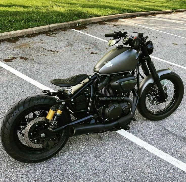 a black motorcycle parked in a parking lot