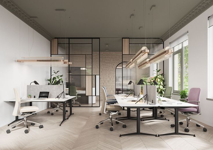 an office with multiple desks and chairs in front of large windows that look out onto the outdoors