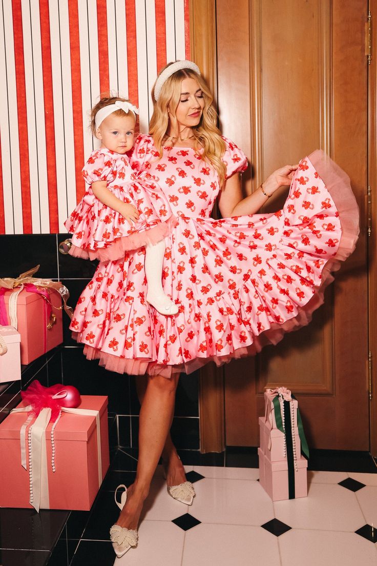 Get in touch with your sweet side in our Scottie Dress! Made from pink satin fabric with a playful candy cane print, this knee-length dress features a square neckline and short puff sleeves. The tulle and tiered hem add extra volume and pockets provide convenience. Complete with a hidden back zipper and fully lined for comfort. Perfect for your festive gatherings this holiday season! Ivy City Women's Scottie Dress Candy Canes | Size: XL Pink Satin Fabric, Thanksgiving Dress, Girls Holiday Dresses, City Woman, Holiday Attire, White Dress Party, Holiday Party Dresses, Mom Dress, Candy Canes