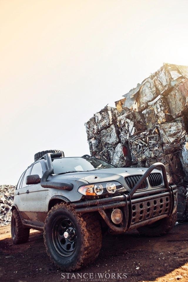 an off - road vehicle is parked in front of some rocks