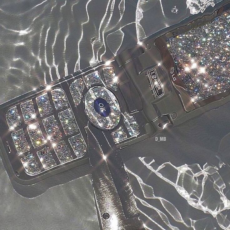 an aerial view of a cell phone in the water with lots of diamonds on it