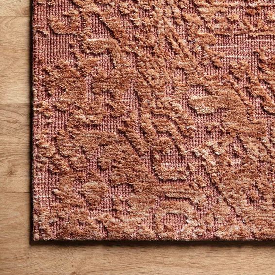 a pink rug on top of a wooden floor