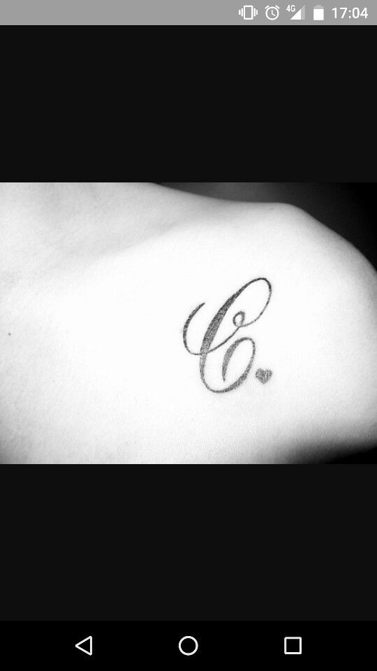 a black and white photo of a woman's arm with the letter g on it