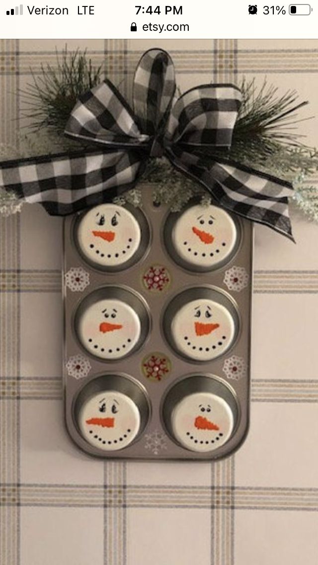 a metal tray with cupcakes decorated like snowmen