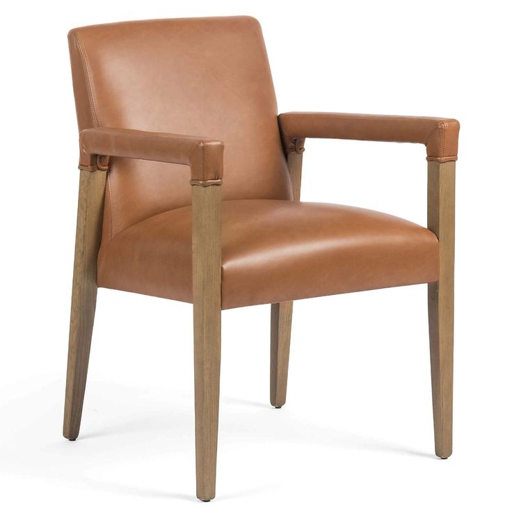 a brown leather chair with wooden legs and arm rests on an isolated white background,