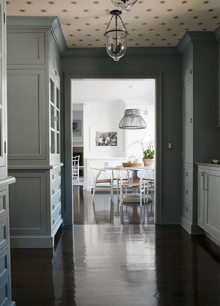 an open door leading to a dining room and kitchen