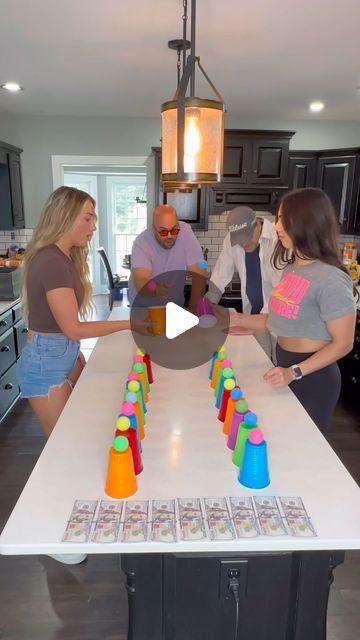 a group of people standing around a kitchen island