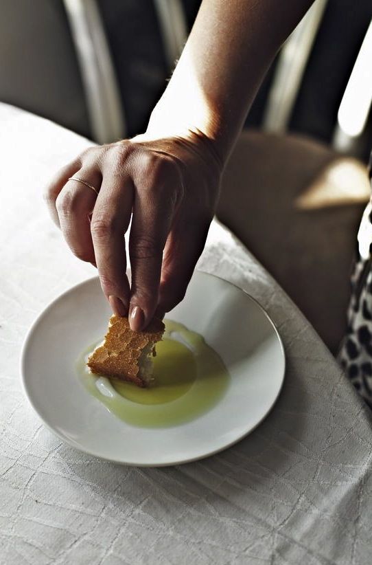 a person picking up food from a white plate