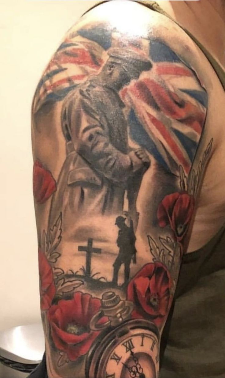 a man's arm with an american flag and clock tattoo on the left shoulder