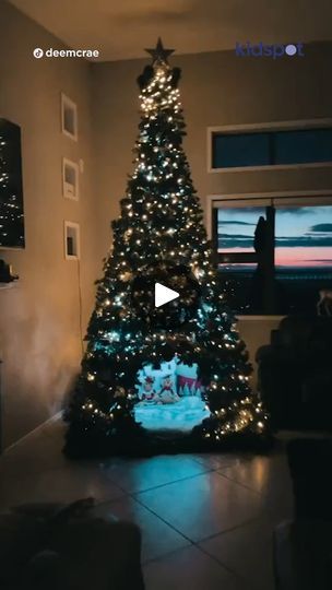 a christmas tree is lit up in the living room