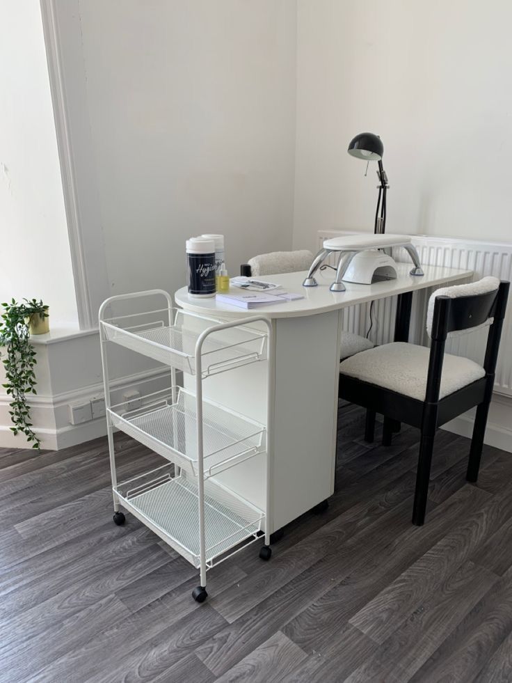 a white desk with two chairs next to it