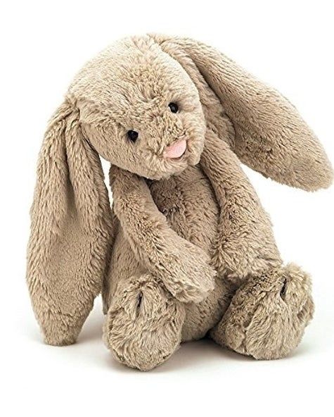 a stuffed bunny rabbit sitting on the ground