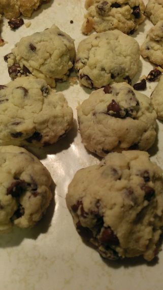 several chocolate chip cookies on a baking sheet