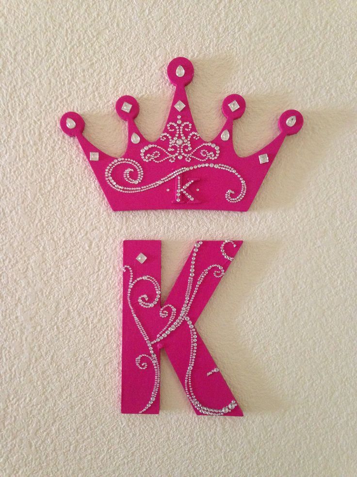 the letter k is made out of plastic and has a crown on it