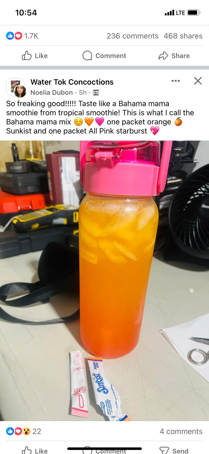 a pink and yellow drink sitting on top of a table