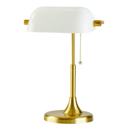 a gold and white lamp on a white background