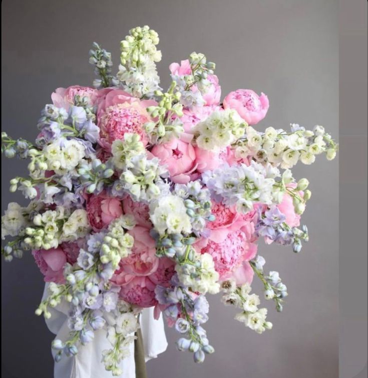 a bouquet of pink and white flowers in a vase