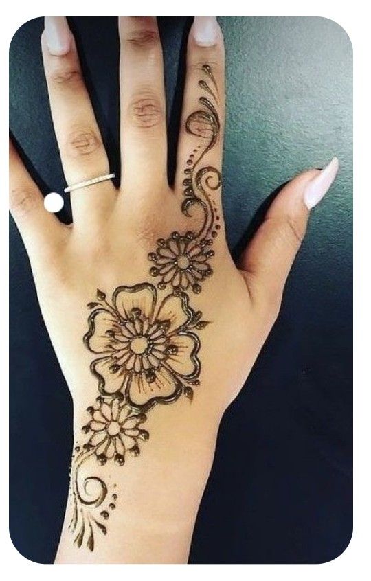 a woman's hand with henna tattoos on it