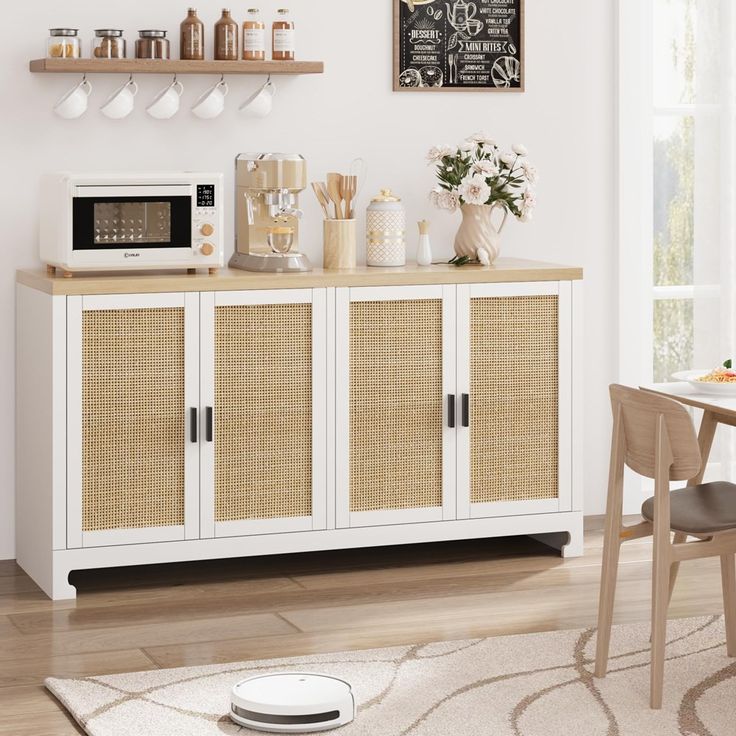 a kitchen area with a microwave, table and chairs in it's centerpiece