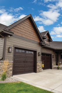 a large house with two garages in the front yard