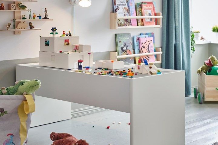 a child's playroom with toys and books on the shelves in front of it