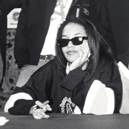 a woman wearing sunglasses sitting at a table