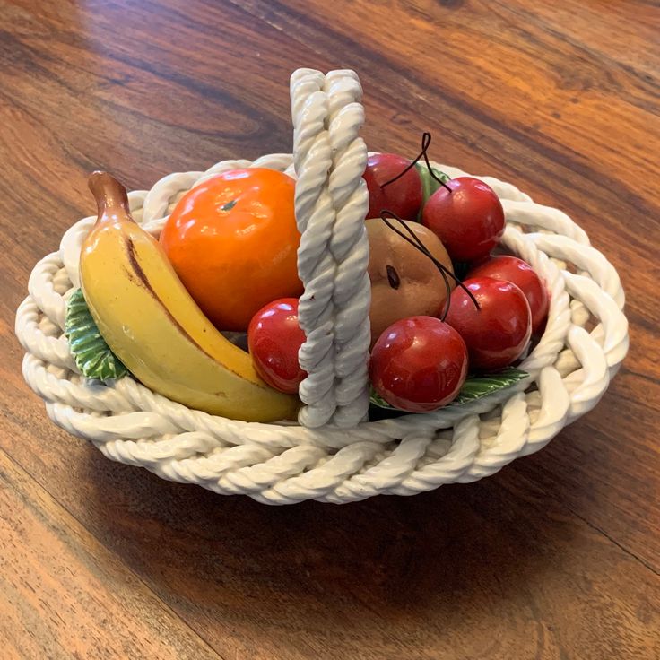 a basket filled with fruit sitting on top of a wooden table