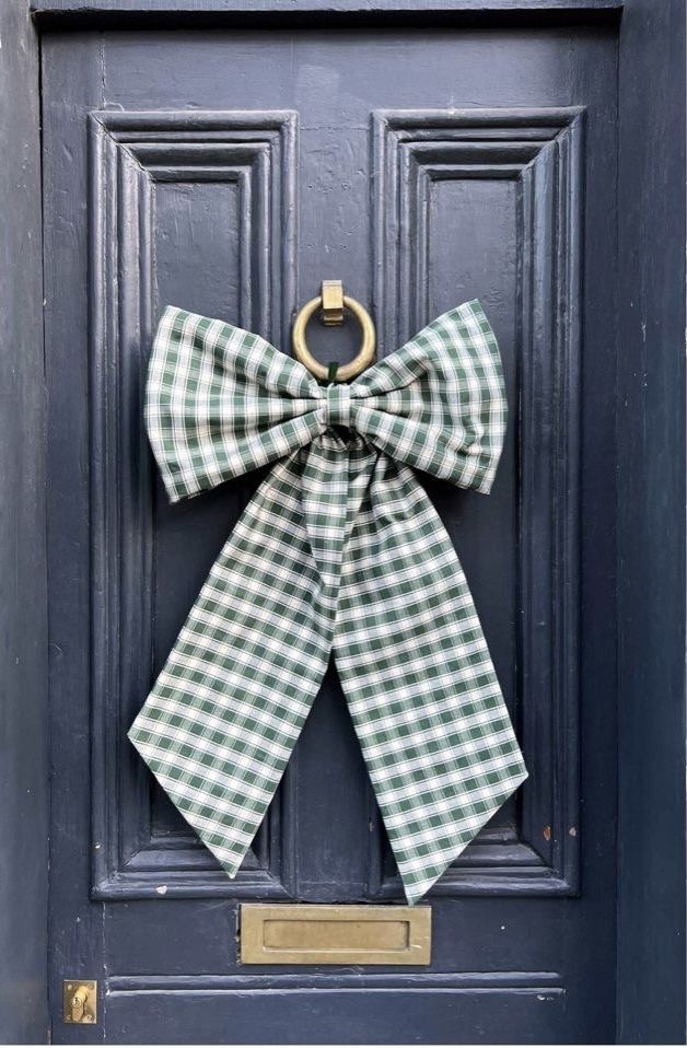 a door with a green and white checkered bow hanging from it's side