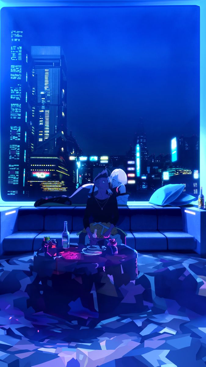 a person sitting at a table in the middle of a room with a city view