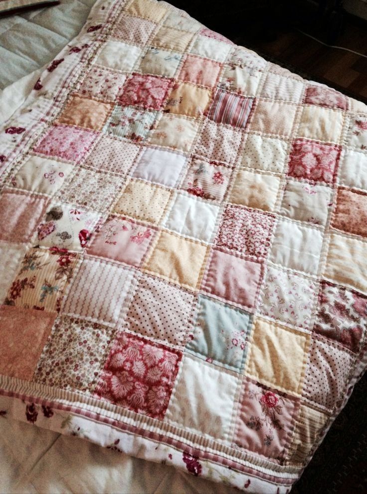 an old quilt is laying on the bed