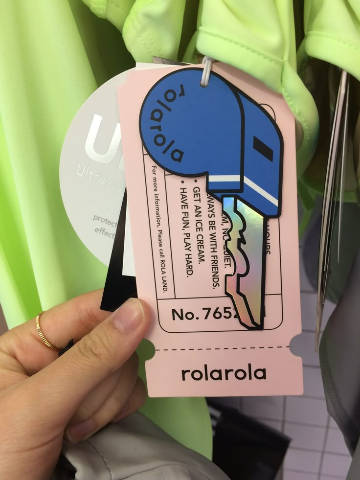 a person holding up a pink tag with an image of a jellyfish on it