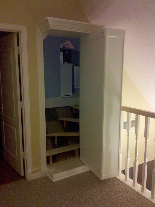 an empty room with a closet in the corner and stairs leading up to the second floor