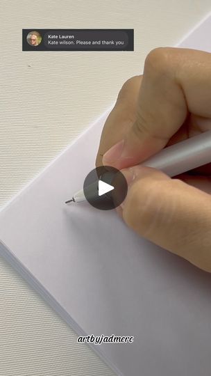 a person is writing on a piece of paper with a pen in their left hand