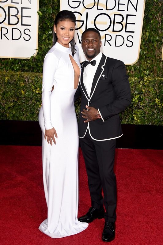 a man and woman posing on the red carpet